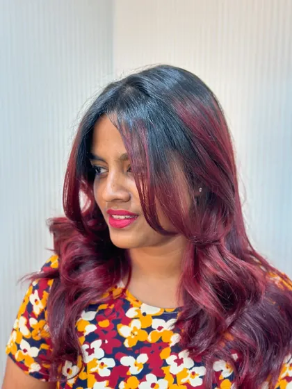 This client is glowing with her new cherry red balayage. It's a bold choice that paid off beautifully.