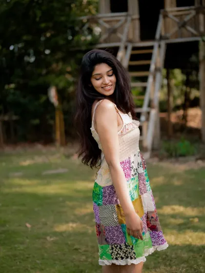 A candid and joyful portrait of actress Rachana Inder in a park. The natural light and her relaxed pose create a beautiful and authentic image.
