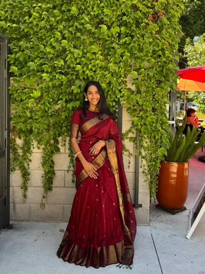 A glimpse into my client diaries with Rishika from the USA. She looks radiant in our viral maroon half saree. This shows how my personalized video consultations and custom fittings ensure a perfect result, no matter where you are in the world.
