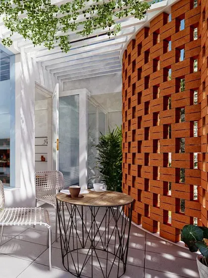 A close-up of a curved balcony featuring a clay block jalli screen. This traditional element is reimagined in a modern context to provide privacy, control sunlight, and cast beautiful, shifting patterns of light and shadow throughout the day.