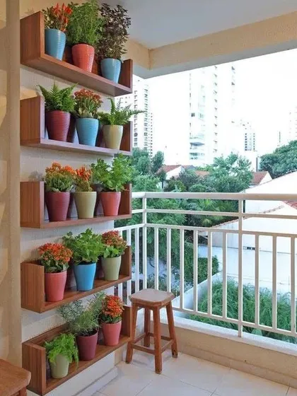 A full view of the vertical shelving unit, showing how it can transform a plain balcony wall into a beautiful and organized plant display with a city view.