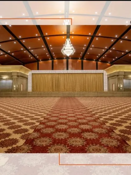 The expansive, patterned carpet and grand stage of our Maanikya hall. This pillarless space offers unobstructed views and a perfect canvas for elaborate stage productions and large gatherings.