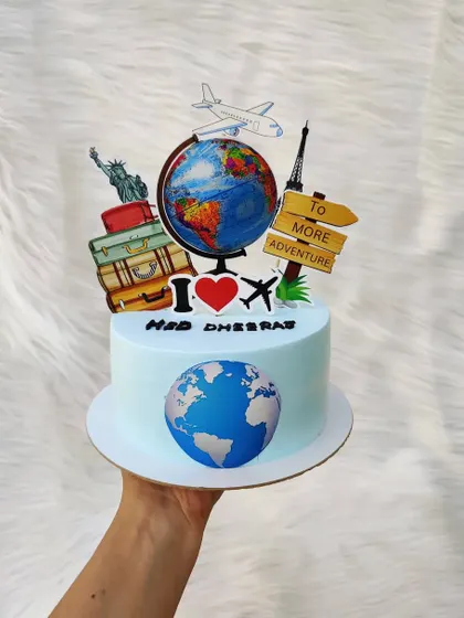 A travel-themed cake for an adventurer. It's decorated with a globe, airplane, luggage, and famous landmarks to inspire wanderlust.