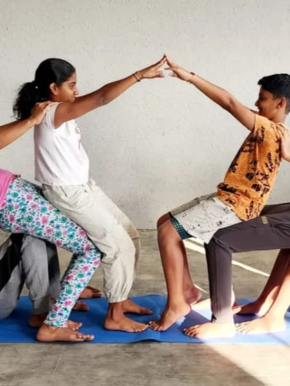 Forming a bridge of strength and friendship, this group pose is a favorite at our camp, symbolizing unity and shared goals.