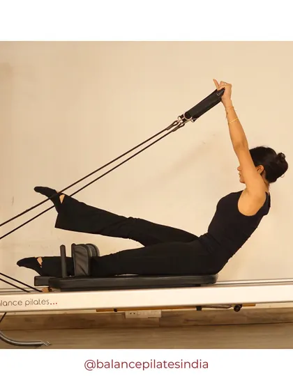 The teaser with straps adds assistance and resistance, helping to perfect the form of this challenging core exercise.