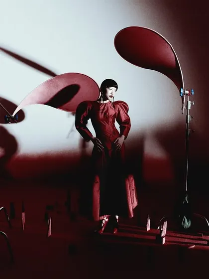 A wide shot that reveals the set design and lighting setup. This behind-the-scenes perspective shows the process of creating the final, polished image.