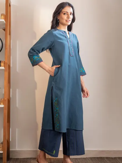 A full-length view of our Haveli Crewel Blue Kurta, styled with matching pants. The straight fit and side pockets make it a practical and elegant choice for everyday wear.