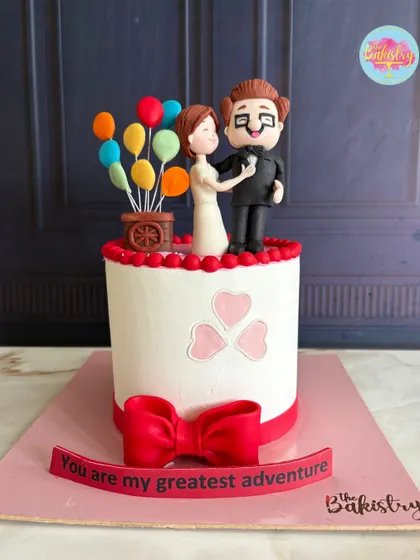 A full view of the "Up" themed cake, with the message "You are my greatest adventure."