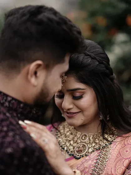 An intimate close up, focusing on the bride's serene expression as the groom holds her. This photo is all about quiet emotion and connection.