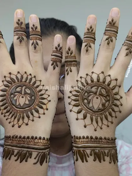 A happy client showing off her lotus mandala design. This is a great choice for someone who wants a beautiful design without full coverage.
