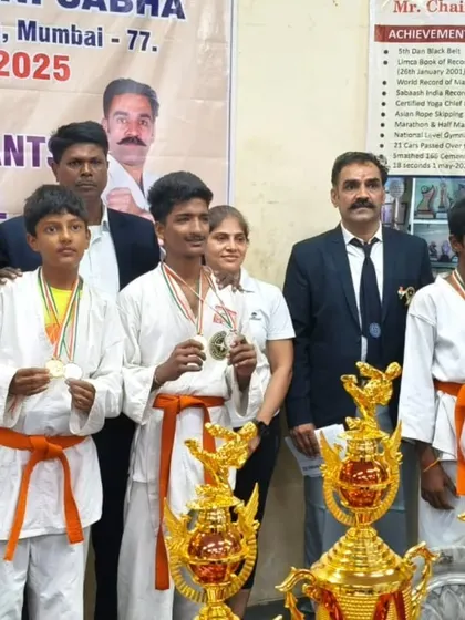 I stand proudly with my students, who are displaying the medals they won at the state-level tournament. Seeing them succeed is my greatest reward.
