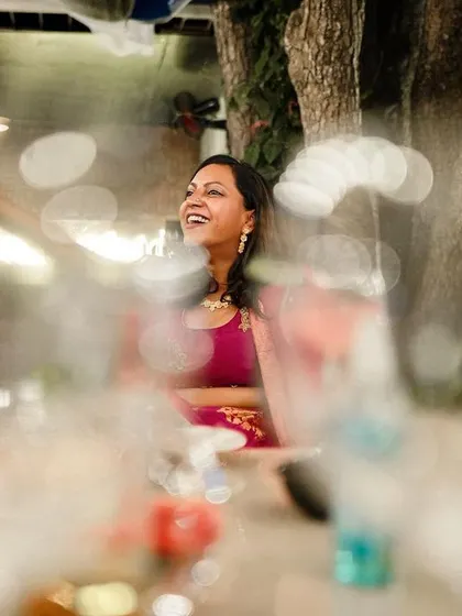 A guest laughs heartily, captured in a candid moment during a lively reception party.