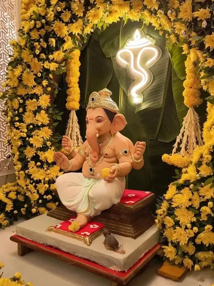 For festive occasions like Ganesh Chaturthi, I create decor that is both devotional and beautiful. This installation features a Ganesha idol framed by a dense arch of yellow marigolds and a modern neon sign, blending tradition with contemporary design.