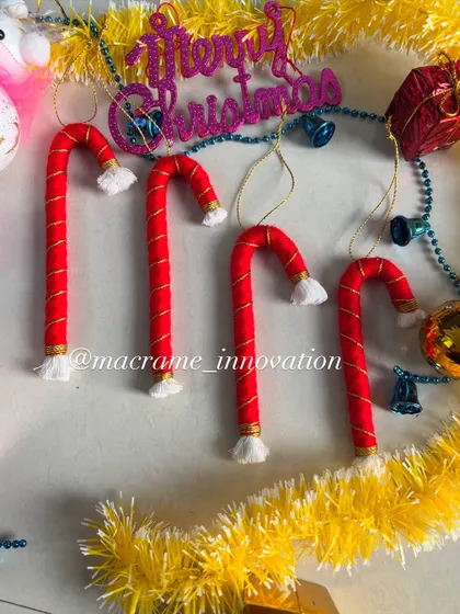 Classic candy cane ornaments, handmade with red and white cord. They look so sweet hanging on a Christmas tree.
