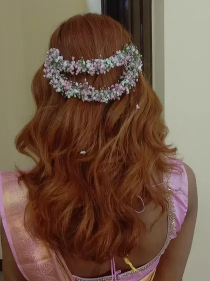A unique half-up style on colored hair, featuring a double crown made of baby's breath.