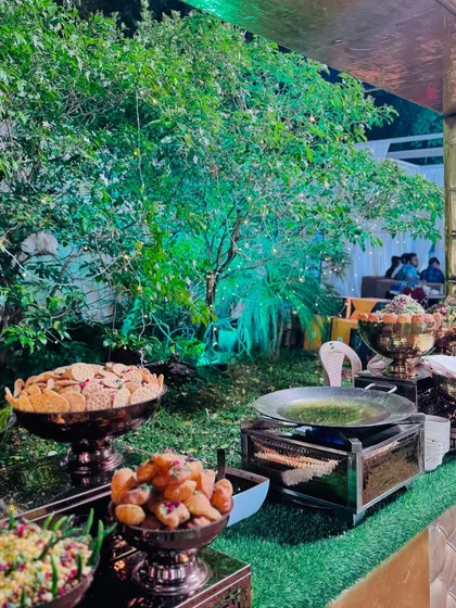 A glimpse of the chaat counter's offerings, including pani puri, sev puri, and bhel puri, all beautifully arranged.