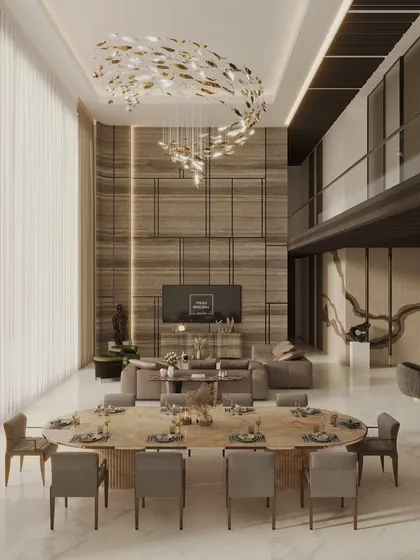 A glimpse into a double-height living and dining area we designed for a luxury penthouse in Mumbai. The space is defined by a dramatic sculptural chandelier, bespoke furnishings, and a mezzanine level, all curated to create an atmosphere of refined elegance.