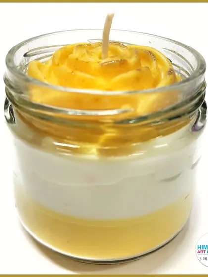 A layered jar candle with a rose-shaped top. We teach techniques for creating scented, colored, and multi-layered candles.