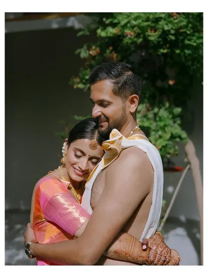 A warm, sun-kissed embrace between the couple, capturing a moment of pure love and contentment.