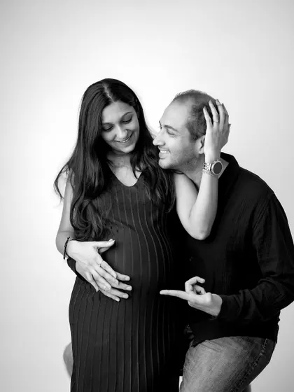 A fun, candid moment between the happy couple. Playful interactions like this make for wonderfully genuine and memorable maternity photographs.