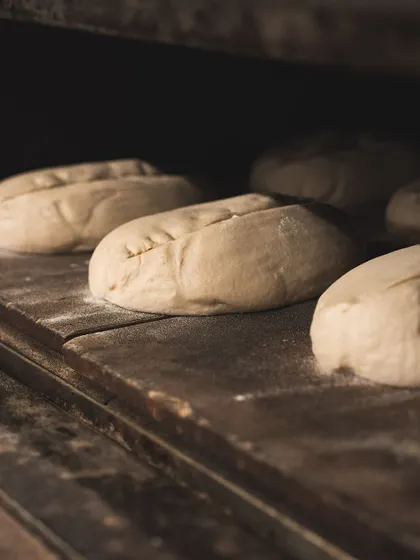 Just before baking, each loaf is scored. This allows the bread to expand in the oven, creating the "ear" and beautiful patterns on the crust.