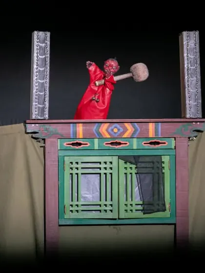 A fearsome red puppet character from 'Hong Dongji & Isimi'. The show tells the story of a mischievous hero who must defeat a monster and a corrupt magistrate.
