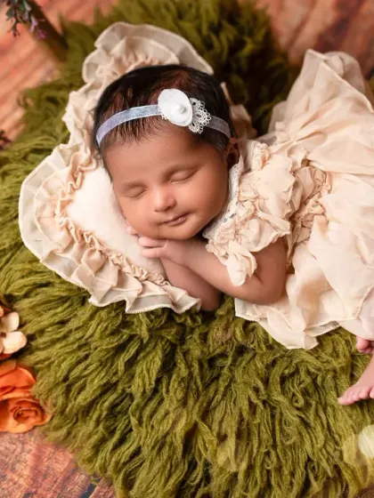 A close-up of a one-month-old baby, showing how their features have started to fill out. Even after the first few weeks, we can capture beautiful, sleepy portraits.