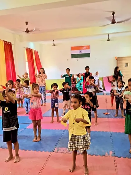 Young children learning basic Taekwondo stances and punches during a summer camp class.