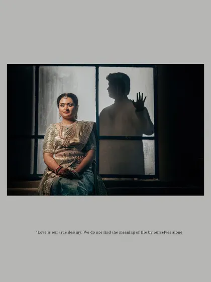 An artistic and moody shot with the bride in focus and the groom's silhouette visible through a window.