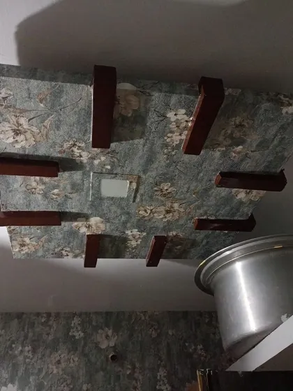 A floral wallpaper applied to a ceiling panel.