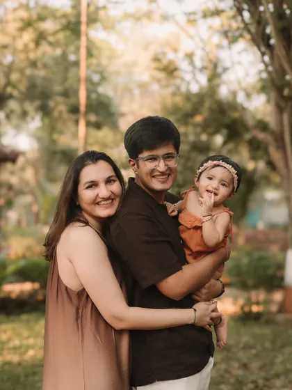 A beautiful portrait of the family together, with the father holding their daughter.