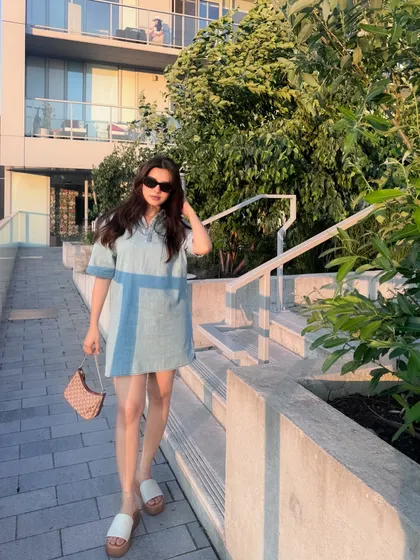 A full-length walking shot to show the movement and casual vibe of the summer outfit.