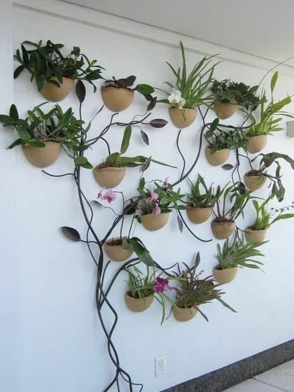 For clients who want something truly unique, I love designing living art. This is an orchid tree we created, using a custom metal frame to display a variety of beautiful orchids on a vertical surface, turning a simple wall into a botanical masterpiece.