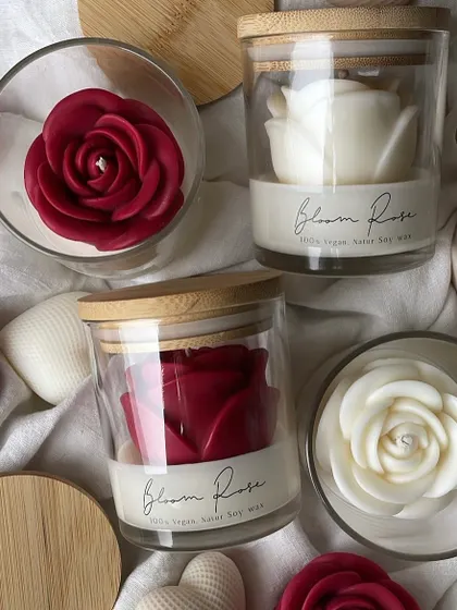 An overhead shot of the Bloom Rose jar candles, showing the beautiful red and white rose designs.