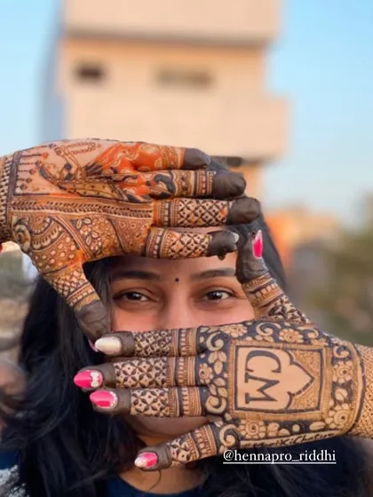 Bridal photoshoots can be so much fun. This shot frames the bride's face with her hands, highlighting the custom initial logo on one palm and a portrait on the other.