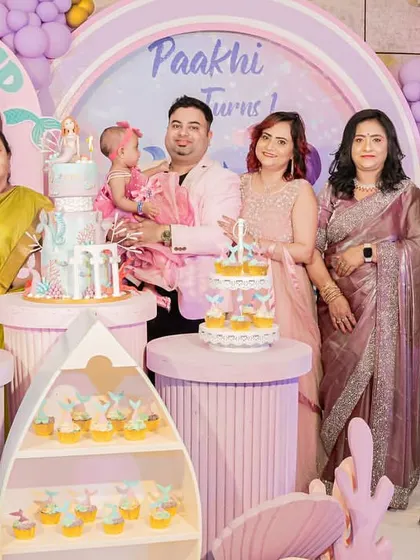 The whole family gathers for a photo at the mermaid-themed first birthday party.