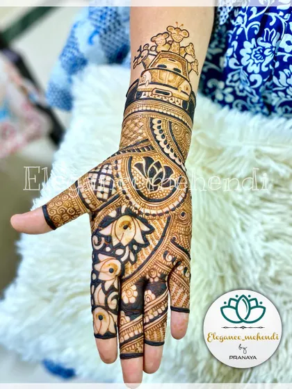 A side view of this adorable baby shower mehendi, showing the cute animals in a car. The lower part of the hand is filled with beautiful lotus and floral patterns.