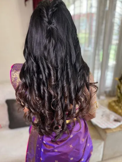 This open, wavy hairstyle is truly here to stay. It's a versatile and beautiful option for any pre-wedding event, from an engagement to a sangeet.