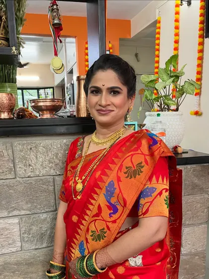 A classic look for a *Munj* (threading ceremony). The client looks elegant and ready for the family function in her beautiful red Paithani saree.