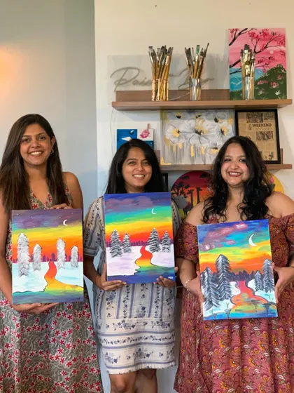 Another group of friends proudly displaying their colorful landscape paintings. The sense of accomplishment is one of the best parts of our workshops.