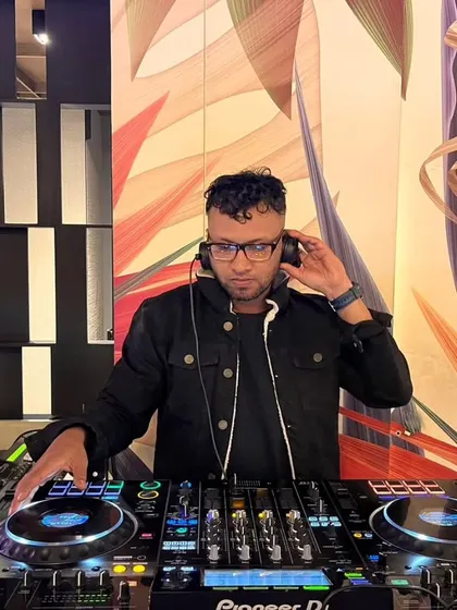 Listening intently through my headphones to cue up the next track perfectly. This is a crucial part of a DJ's craft.