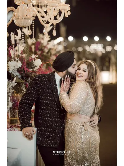 A similar moment of joyful affection, captured from a slightly different angle, showcasing the spontaneous love and happiness of the couple.