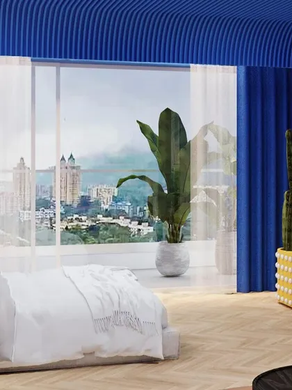 A view of the lounge area, with the city skyline visible through the large windows, creating a contrast between the dreamy interior and the urban exterior.