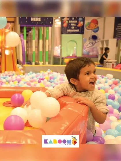 The look of pure excitement! This little one is having a blast in our interactive ball play area.