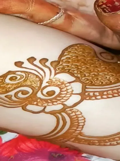 A macro shot of a peacock motif just after the henna paste has been applied. I love getting the details just right, from the feathers on the head to the texture on the body.