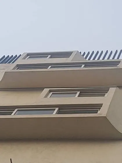 The facade of this building features gracefully curved projections around the windows. This detail adds a soft, sculptural quality to the exterior, playing with light and shadow.