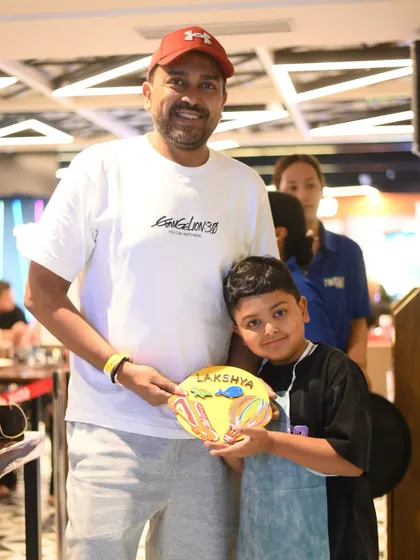 Another happy father and son duo from our Father's Day event. The son's personalized plate is a colorful and heartfelt creation.
