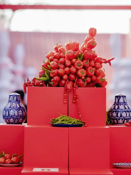 A close-up of the food installation, where I used fresh red tomatoes and peppers as part of the decor, blurring the lines between food and art.