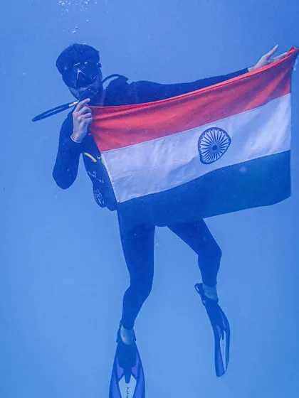 A solo diver poses with the Indian flag during our 75th Independence Day underwater celebration.