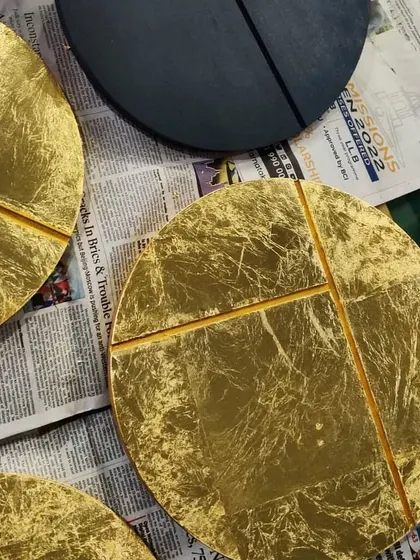 We believe in adding a personal touch to our spaces. These circular wall art pieces were designed and crafted in our own studio for a client's home. Made with wood, vegetable dyes, and gold and silver leaf, they represent the phases of the moon and add a layer of bespoke artistry to the interior.